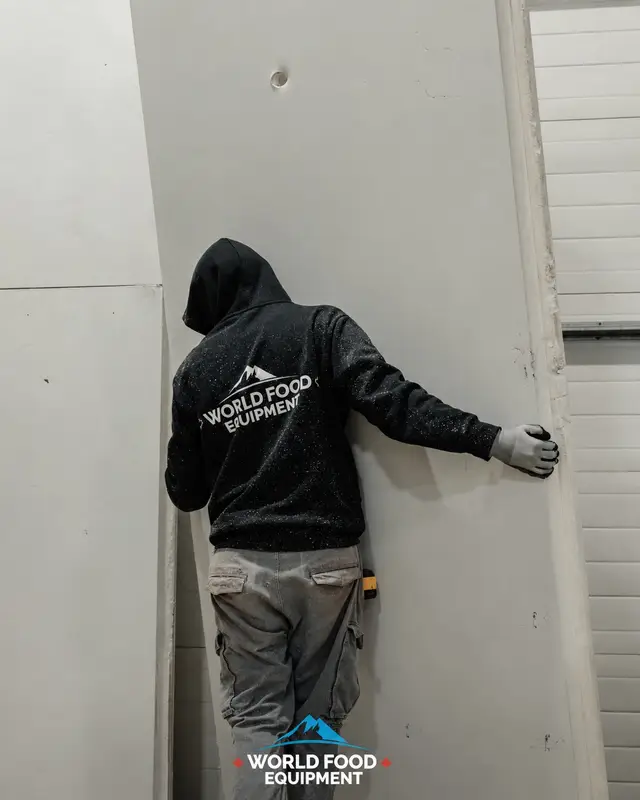 WFE installer setting a walk-in cooler panel in Hamilton